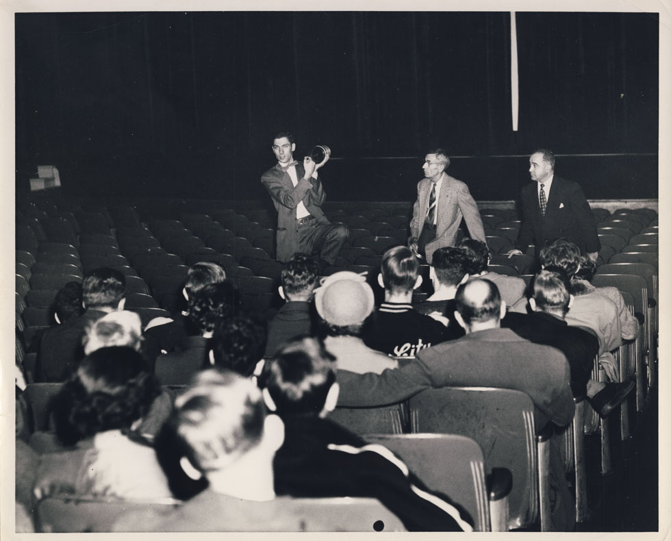 A Bausch & Lomb engineer explains CinemaScope. That's the RKO Palace manager on the right. [PHOTO: D.O. Schultz / Rochester Theater Organ Society]