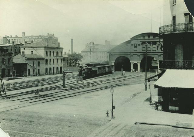 A view of the first New York Central Railroad station located between Mill Street and Front Street. This station replaced a wooden structure, known as the Auburn Railroad shed, in 1852. It remained open until 1883 when a more modern station was constructed.