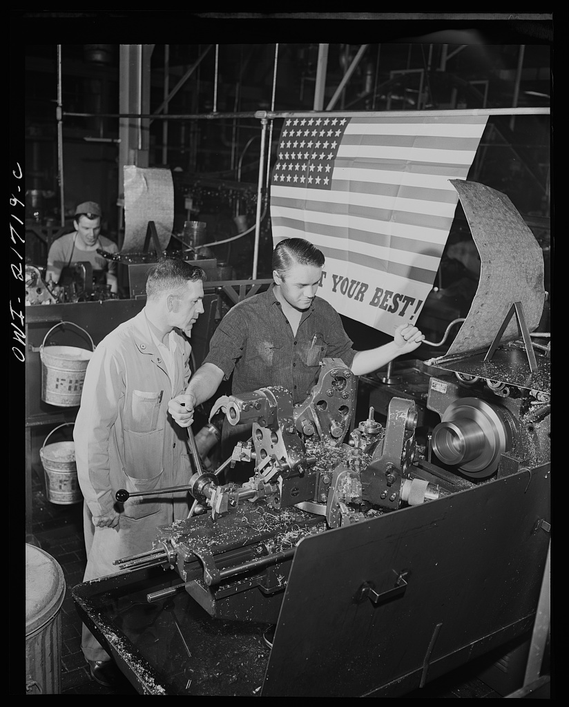 Mr. Babcock explaining an operation to one of the men whom he supervises at the plant [PHOTO: Library of Congress]