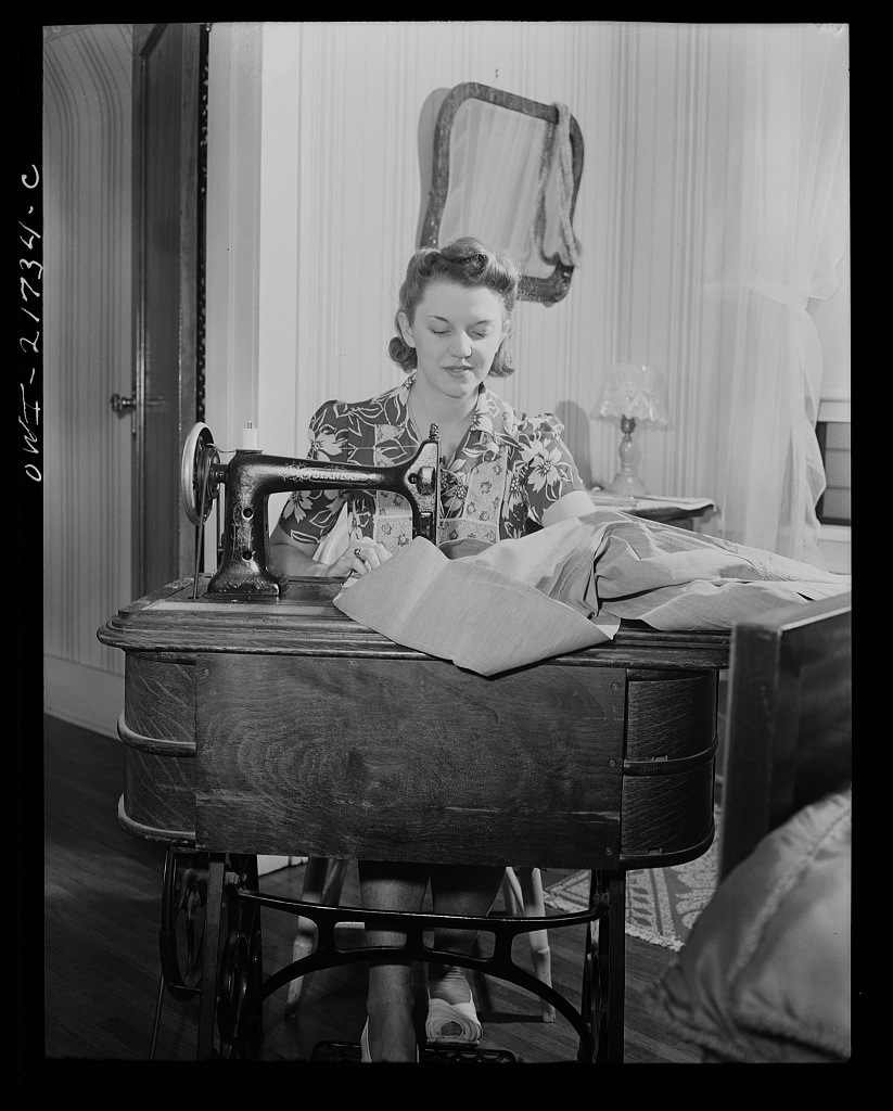 Shirley Babcock is very handy at the sewing machine and she helps her mother with the family sewing [PHOTO: Library of Congress]