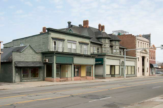 This is a series of pictures taken by Andy Olenick (April, 2011) in an effort to document the buildings before they were torn down. This view, looking northeast, shows the buildings on the north side of East Avenue, including the shuttered businesses of Old Brighton Antiques at 1794 East Ave. and Cyrus Oriental Rugs at 1796. [PHOTO: Andy Olenick, Rochester Public Library]