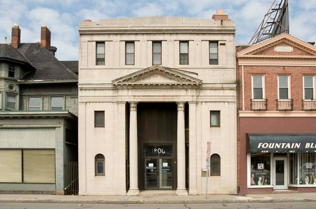 The building which formerly housed Safelink Supply and Upstate New York Alarm. The building once housed a bank. [PHOTO: Andy Olenick, Rochester Public Library]