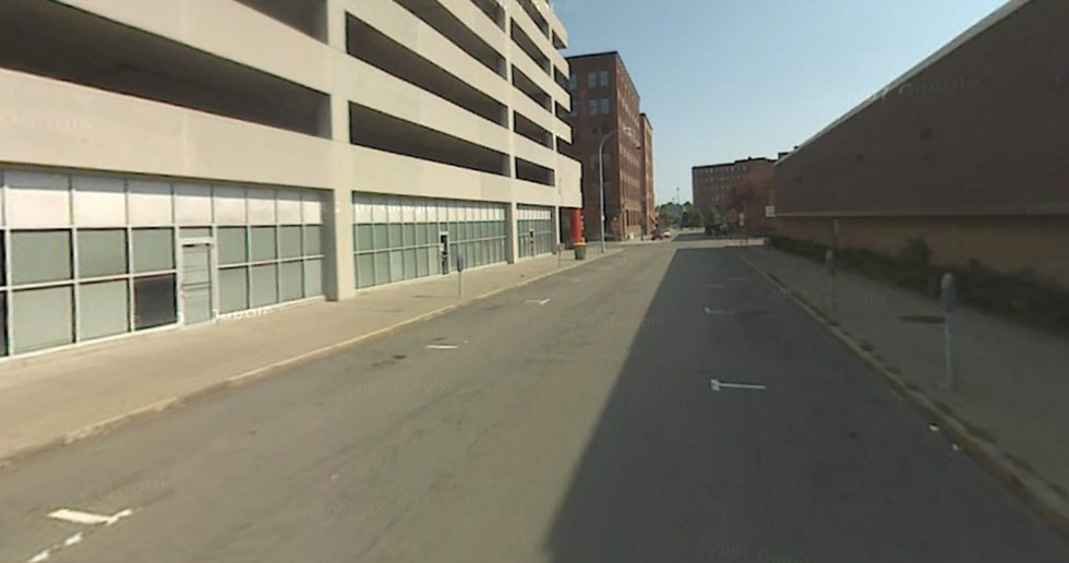 This is an example of a deadzone in the High Falls neighborhood, with blocked out windows on one side of the street, and a solid wall along the other side. [PHOTO: Google Streetview]