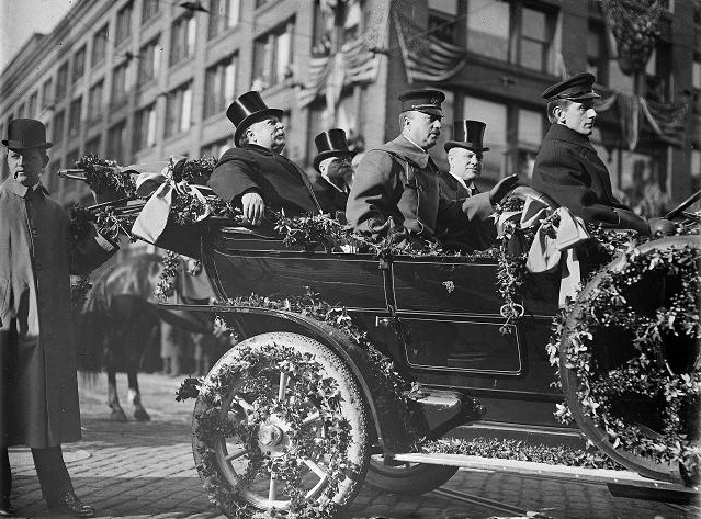 President William Taft arriving in Rochester for his visit to the National GAR Encampment. He is riding from the train station to Hotel Seneca. Taft is in the back seat on the left. Next to him is Mayor Hiram Edgerton. In the front seat are Archibald Butt, the president's personal military aide, and George Dietrich, president of the chamber of commerce. March 18, 1910. [PHOTO: Albert R. Stone]