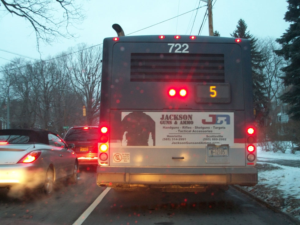An ad for guns and ammo on the back of an RTS bus. February 1, 2013. [PHOTO: RochesterSubway.com]