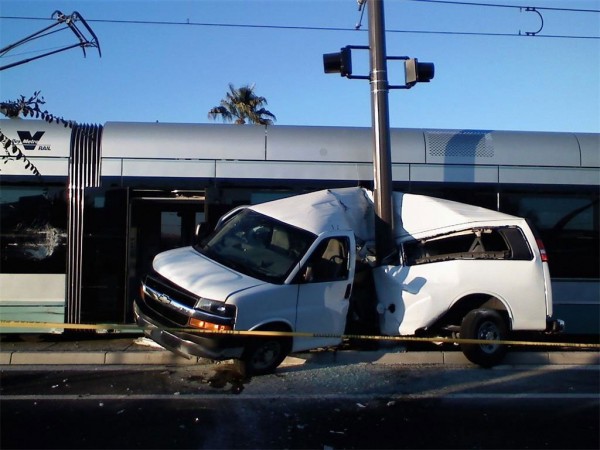 A light rail commuter train crushes a passenger van in Phoenix Arizona after the van ran a red crossing signal.