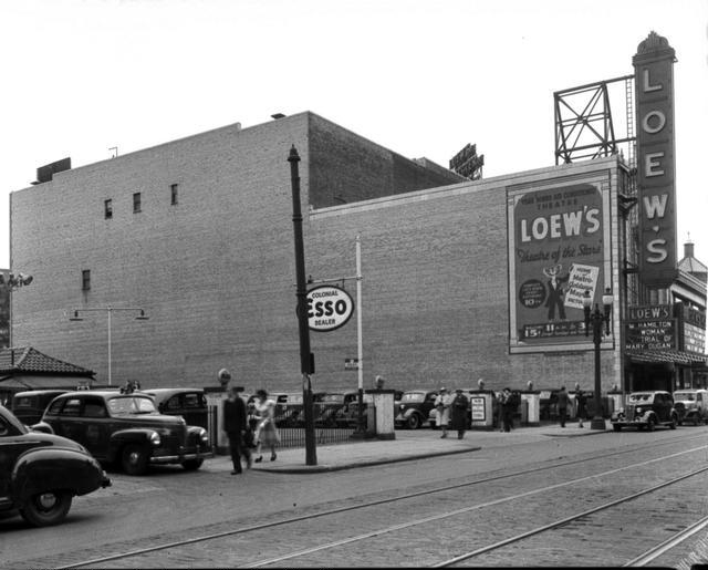 Loew's Theatre, 120 South Clinton Avenue, on the east side of the street north of Court Street. A car parking lot is next to the theater. May 5, 1941. [PHOTO: Rochester Municipal Archives]