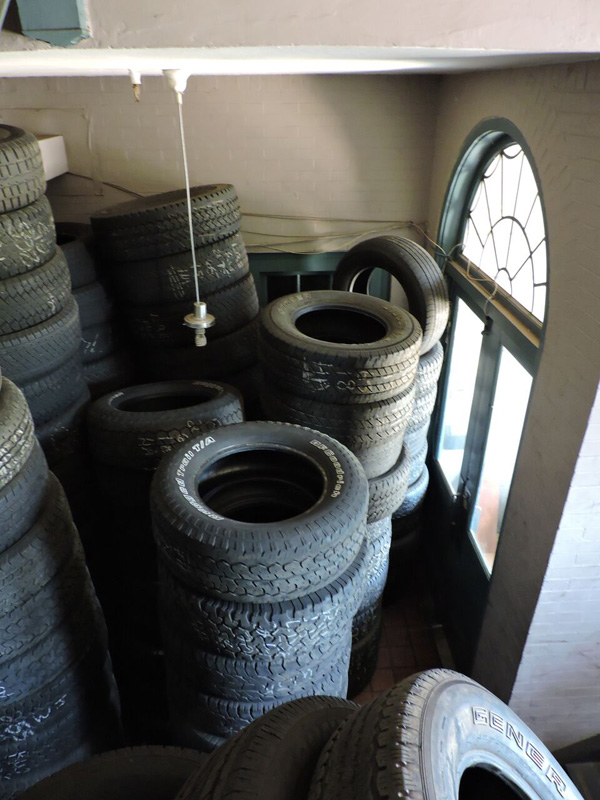 Front entryway of the building; tires are in what was the foyer. [PHOTO: Joanne Brokaw]