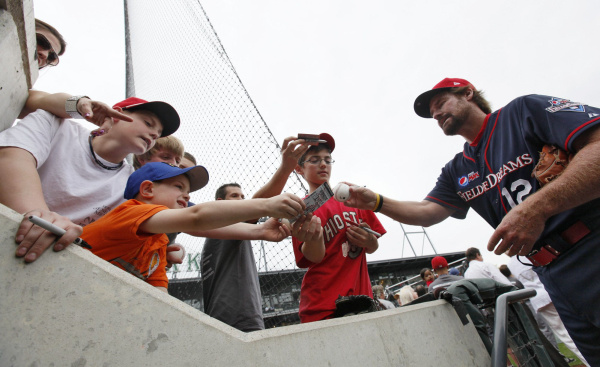 Former Boston Red Sox third baseman Wade Boggs signs autographs before the start of the exhibition game, which was sponsored by Pepsi Max. [PHOTO: Chris Russell, Columbus Dispatch]