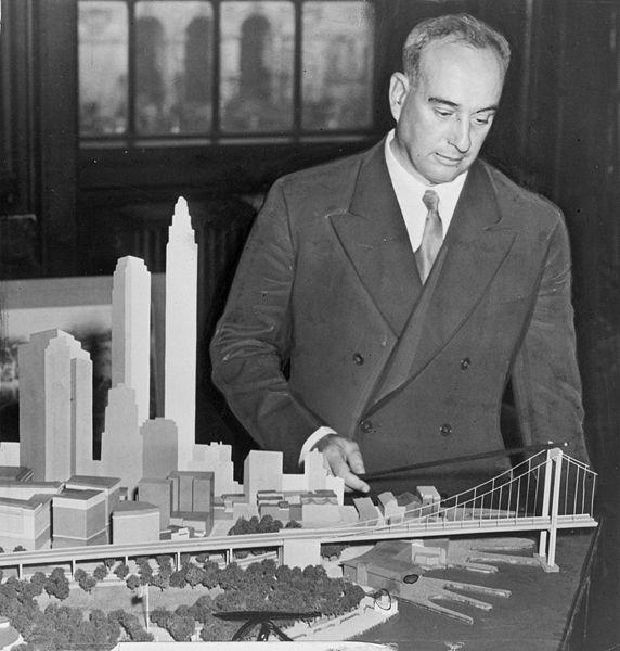 Robert Moses, American urban planner, with a model of his proposed Battery Bridge.