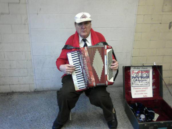 Walter, Rochester's accordion man, playing outside an Amerks hockey game in the War Memorial parking garage tunnel. [PHOTO: Craigslist]