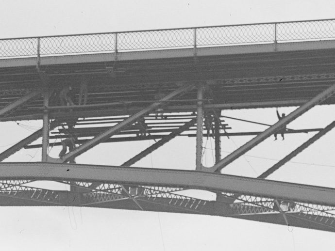 Several workers beneath the road deck of the Driving Park Bridge, Rochester, NY.