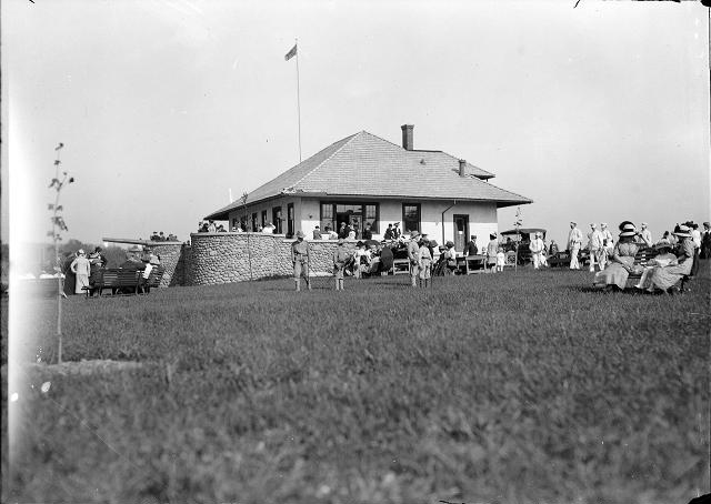 People gather at the new refectory at Durand-Eastman Park on its opening day in 1912. Members of the band approach at the right. [PHOTO: Albert R. Stone]