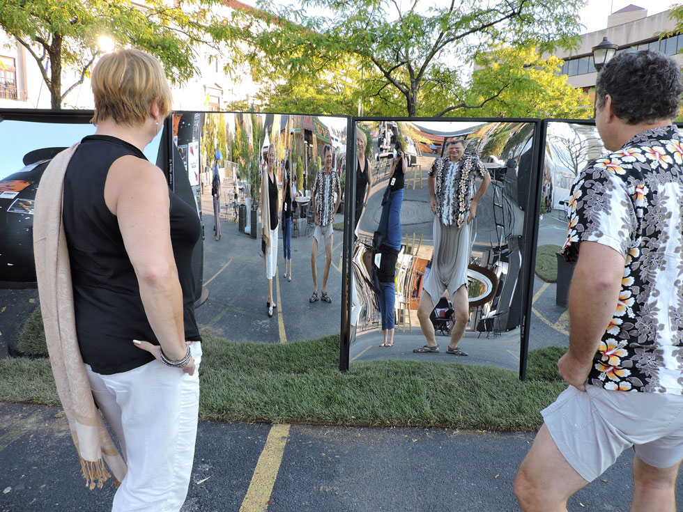 Nancy and Scott Grove enjoy Scott's installation, the Wall of Mirrors. [PHOTO: Joanne Brokaw]