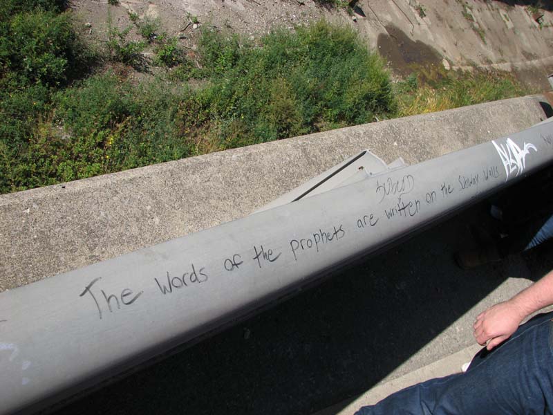Art is sometimes a bit cheeky. 'The words of the prophets are written on the subway walls' says the guy writing on railing above the subway entrance.