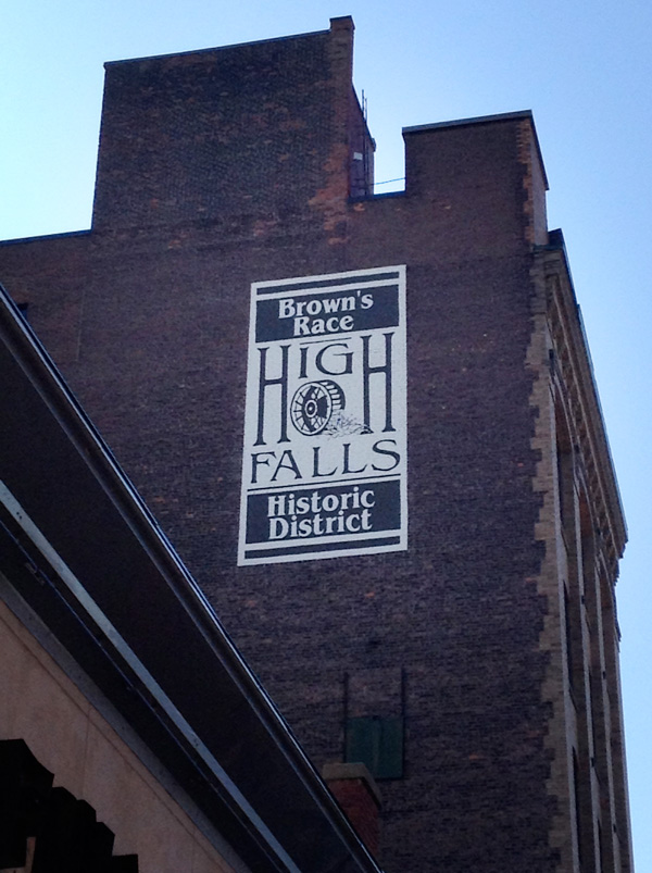 The High Falls Business Association has been repainting some of the old 'ghost' advertising signs on buildings along Mill Street. The High Falls waterwheel logo is a new addition. [PHOTO: RochesterSubway.com]