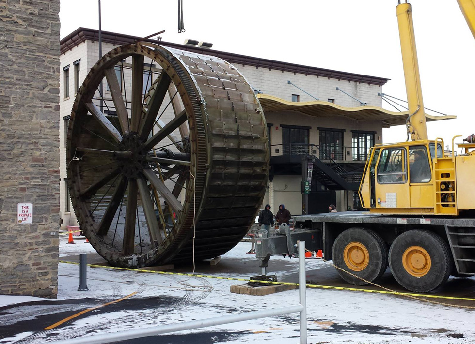 The triphammer water wheel in High Falls, Rochester NY being removed from its housing so it can be restored. [PHOTO: Tom Dubois]