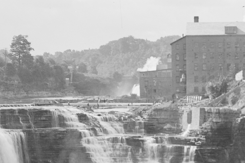 This was a busy busy time in Rochester. These workers on the rim of Lower Falls are constructing a dam, several feet high to regulate the flow for the electric generators.
