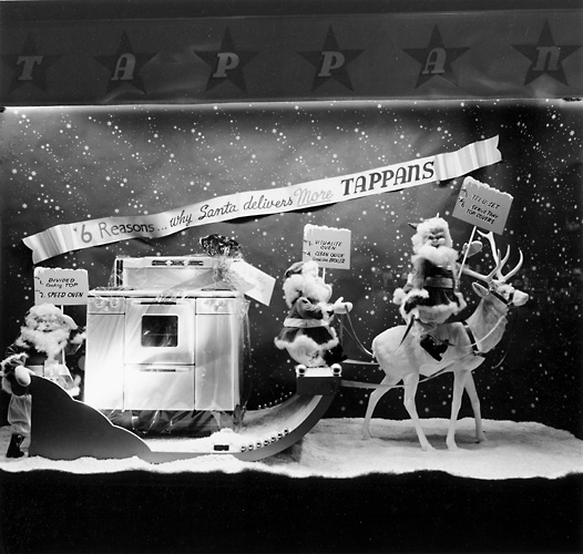 This scene shows Santa Claus in a sleigh carrying a Tappan range. 'Six reasons why Santa delivers more Tappans.' c.1940. [PHOTO: Rochester Public Library]