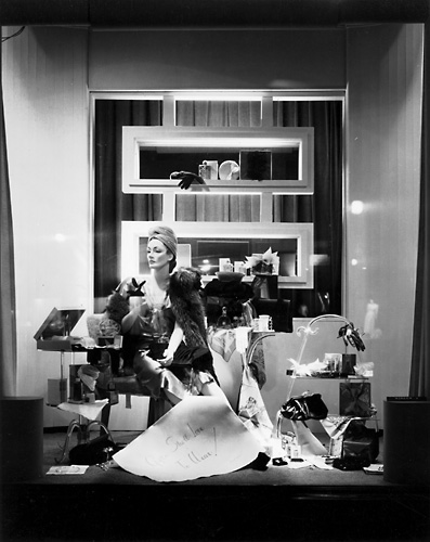 'Gifts she'll love to wear!' This scene features a mannequin in a fashionable dress posed alongside of various accessories. c.1940. [PHOTO: Rochester Public Library]