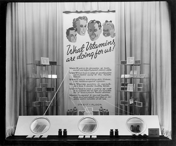 'What vitamins are doing for us!' A display of vitamins for sale. c.1940. [PHOTO: Rochester Public Library]