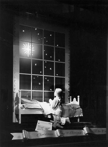 'Christmas, Keep it Shining for all the World.' This scene shows a child praying before a Christmas star. c.1940. [PHOTO: Rochester Public Library]