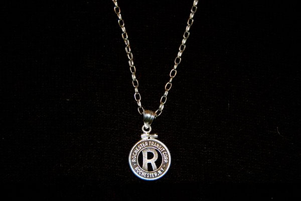 Paul Schacht bought a token from RochesterSubway.com and took it to Glen Moscoe Jewelers (S. Clinton Ave.) where, for under $50, they promptly turned it into a necklace for his daughter. Paul tells us she's a big fan of trains and the Rochester subway in particular.