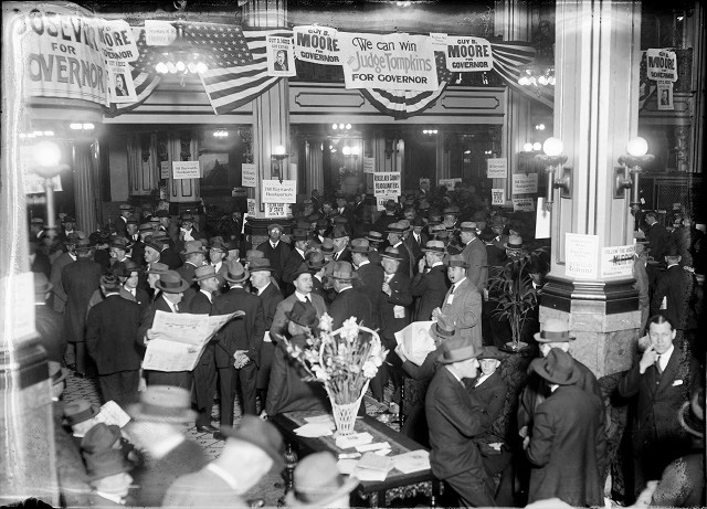 Delegates to the New York State Republican convention gather in the lobby of the Seneca Hotel. Posters show support for various candidates for nomination. c.1924 [PHOTO: Albert R. Stone Collection]