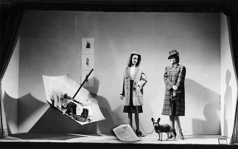 A Sibley's window display featuring mannequins wearing raincoats, pictured with umbrellas. c.1940. [PHOTO: Rochester Public Library]
