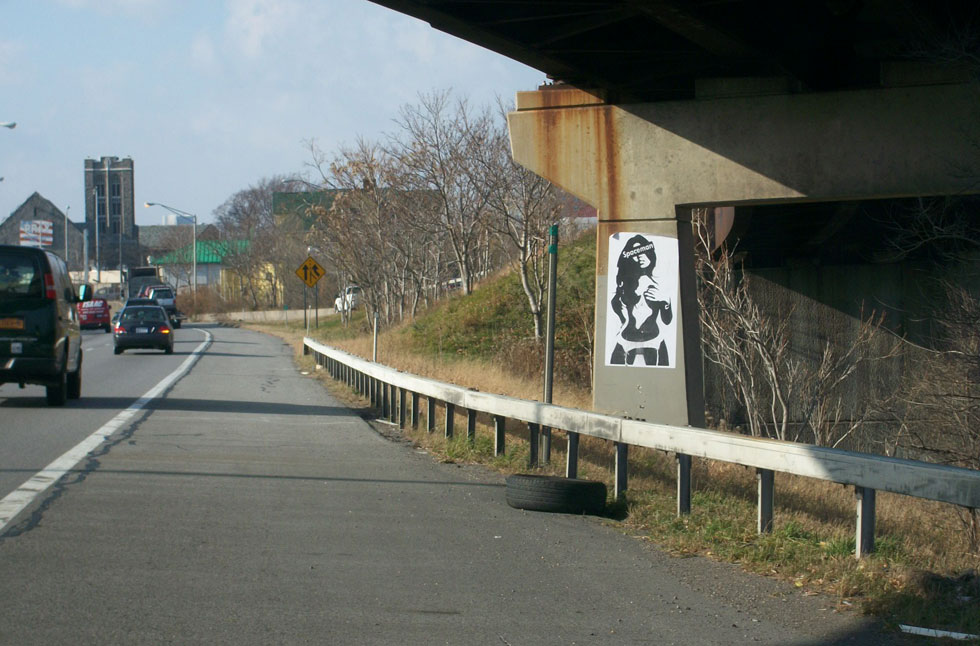 A Spaceman poster on the side of I-490 at the Can of Worms interchange.