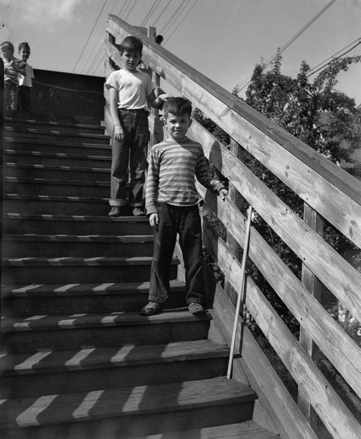 Children pose on the steps of a footbridge over the Rochester Subway, just west of the Monroe Avenue Station near Adwin Place. [Image from Rochester Municipal Archives]