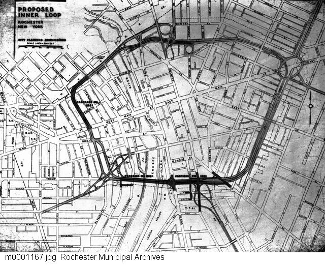 A photograph of a map showing the proposed outline for the Inner Loop. The Inner Loop was proposed in 1947 as part of the Rochester arterial plan, which also included plans for the Outer Loop and connecting expressways. The Inner Loop would be a circular highway surrounding the downtown business district and relieving traffic congestion downtown. Demolition for the Inner Loop began in 1952, and the project was completed in 1965.
