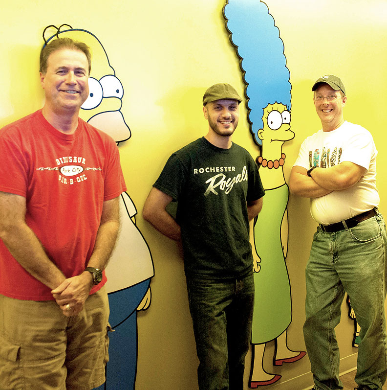 From left to right: Bill Bemiller (wife from Rochester), Mike Battle (Rochester), and Norm Auble (Spencerport) all work together on The Simpsons. [PHOTO: Brooks Stonestreet]