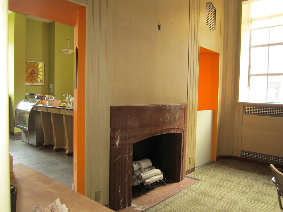 There's now an Orange Glory Cafe on the first floor. This fireplace was discovered hiding under drywall. [PHOTO: Ryan Green]
