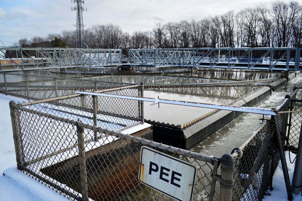 PEE and PEW? PEE stands for Primary Effluent East. The tanks on the other side are PEW; Primary Effluent West. Effluent is liquid waste. [PHOTO: RochesterSubway.com]